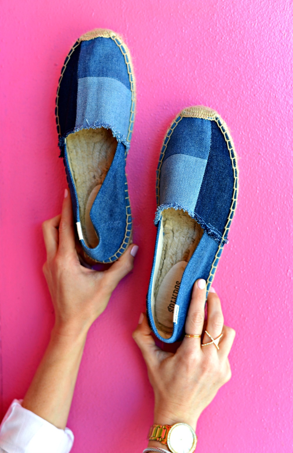 Denim espadrilles by soludos | Casual Valentine’s Day outfit styled by top US fashion blog, The Modern Savvy: image of a woman wearing a BB Dakota blouse, BlankNYC jeans, Soludos flats, Gorjana ring, Baublebar rings and David Yurman bangle
