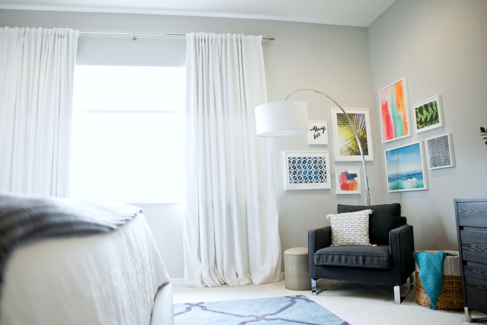 A designer shares her best tips for creative a chic, cohesive gallery wall // the modern savvy - Master bedroom refresh -- bright and light master bedroom decor (before & after) with grey upholstered headboard by popular Florida style blogger The Modern Savvy