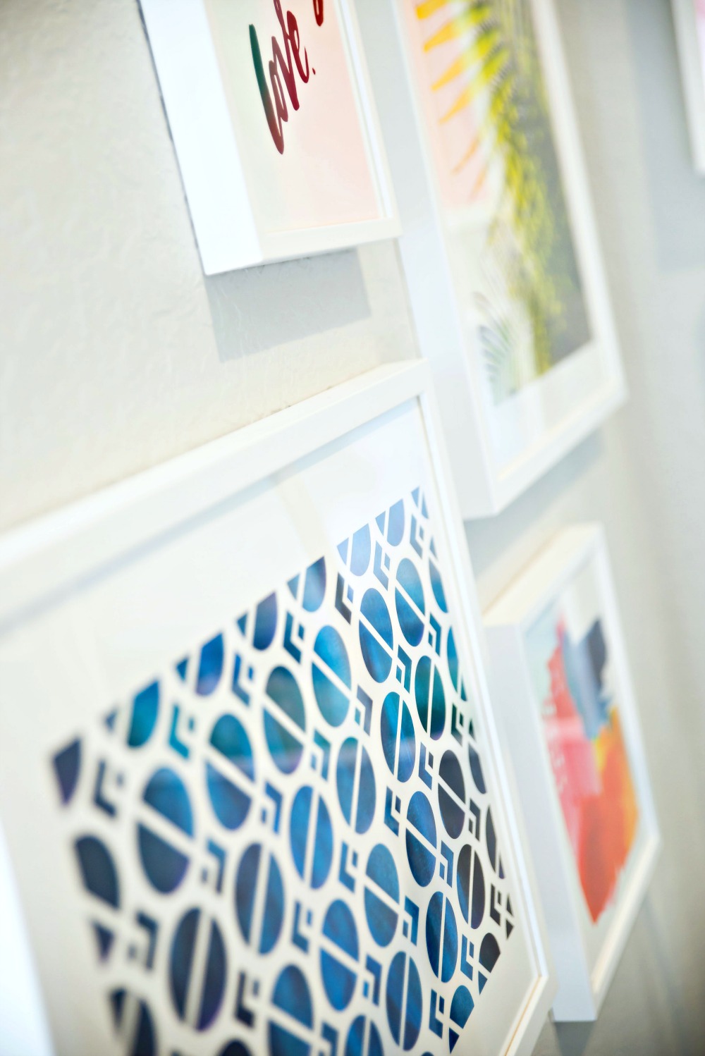 A bright, airy gallery wall for this coastal master bedroom 