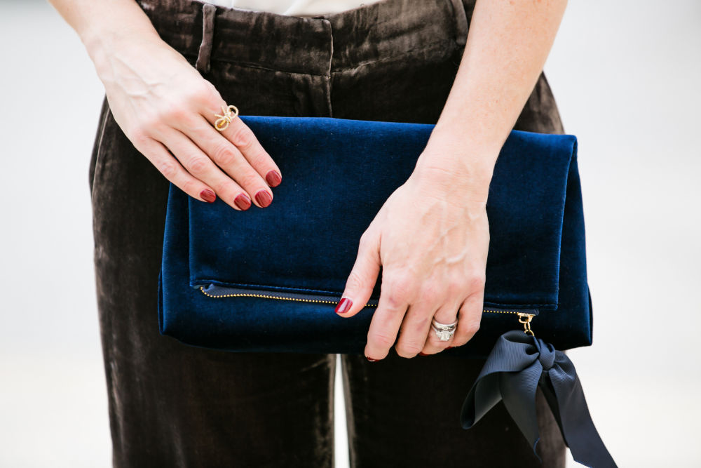 Velvet clutch -- accessories to up your holiday outfit #momstyle #holidayootd | Black Velvet Pants for the Perfect Holiday Outfit featured by top Florida fashion blog The Modern Savvy