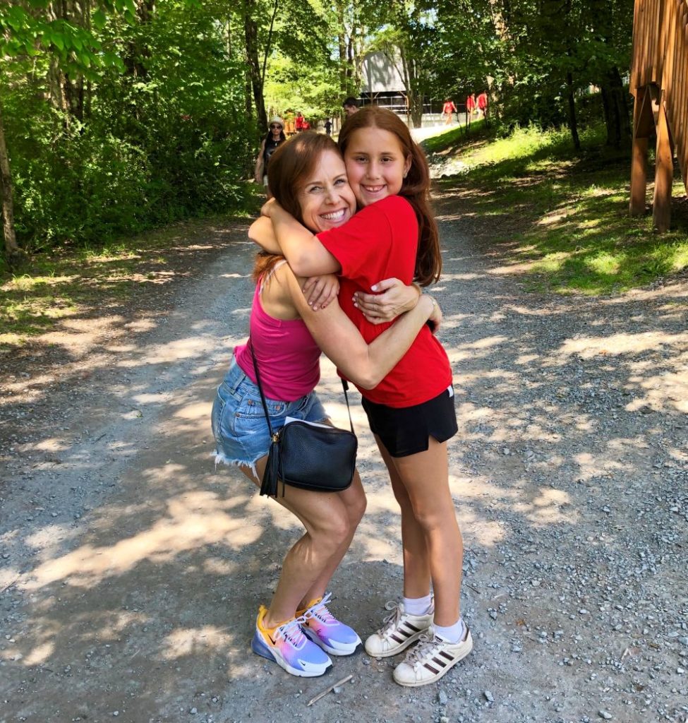 Alyson's Recent Favorites // July 2019 by popular Florida lifestyle blog: The Modern Savvy: image of a woman hugging her daughter outside and wearing a pair of Nike Air Max 270.