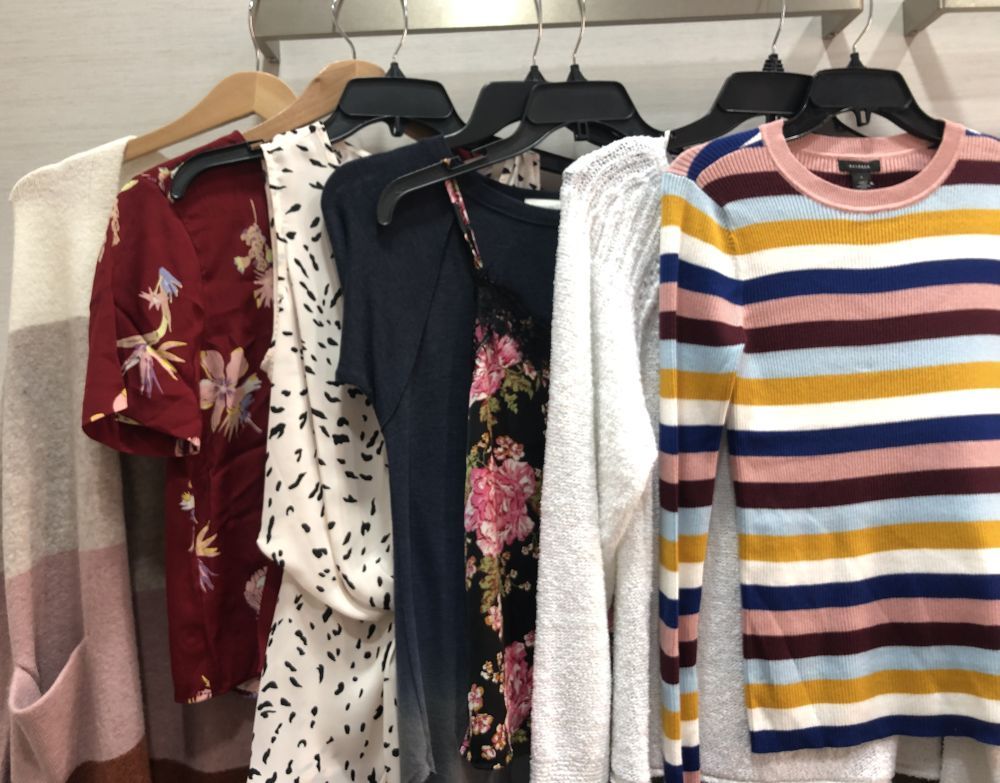 Nordstrom Anniversary Sale 2019: Fitting Room Try-On Session & My Favorite Under $100 finds! by popular Florida fashion blog, The Modern Savvy: image of shirts hanging on clothing rack inside a Nordstrom changing room. 