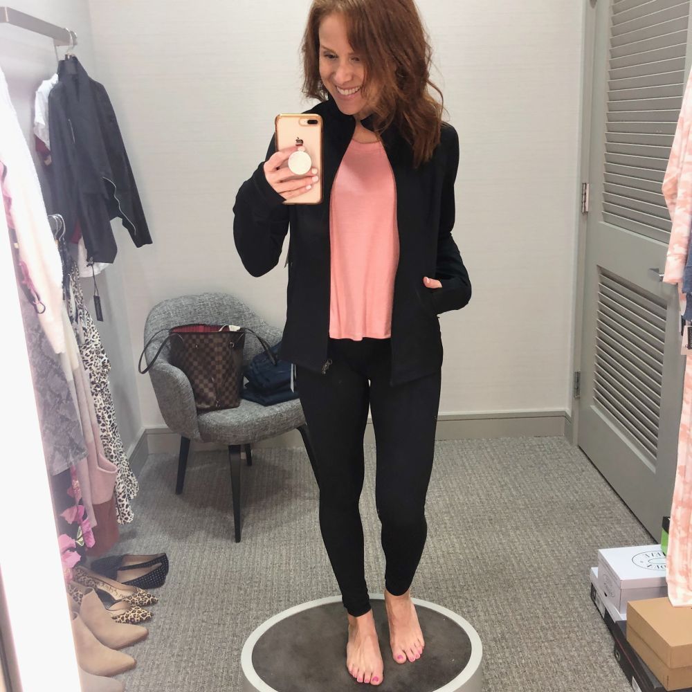 Nordstrom Anniversary Sale 2019: Fitting Room Try-On Session & My Favorite Under $100 finds! by popular Florida fashion blog, The Modern Savvy: image of woman inside a Nordstrom dressing room wearing a Zella Live In Jacket, Zella Splits Ribbed Tank, Zella bra, and Zella Live In High Waist Leggings. 