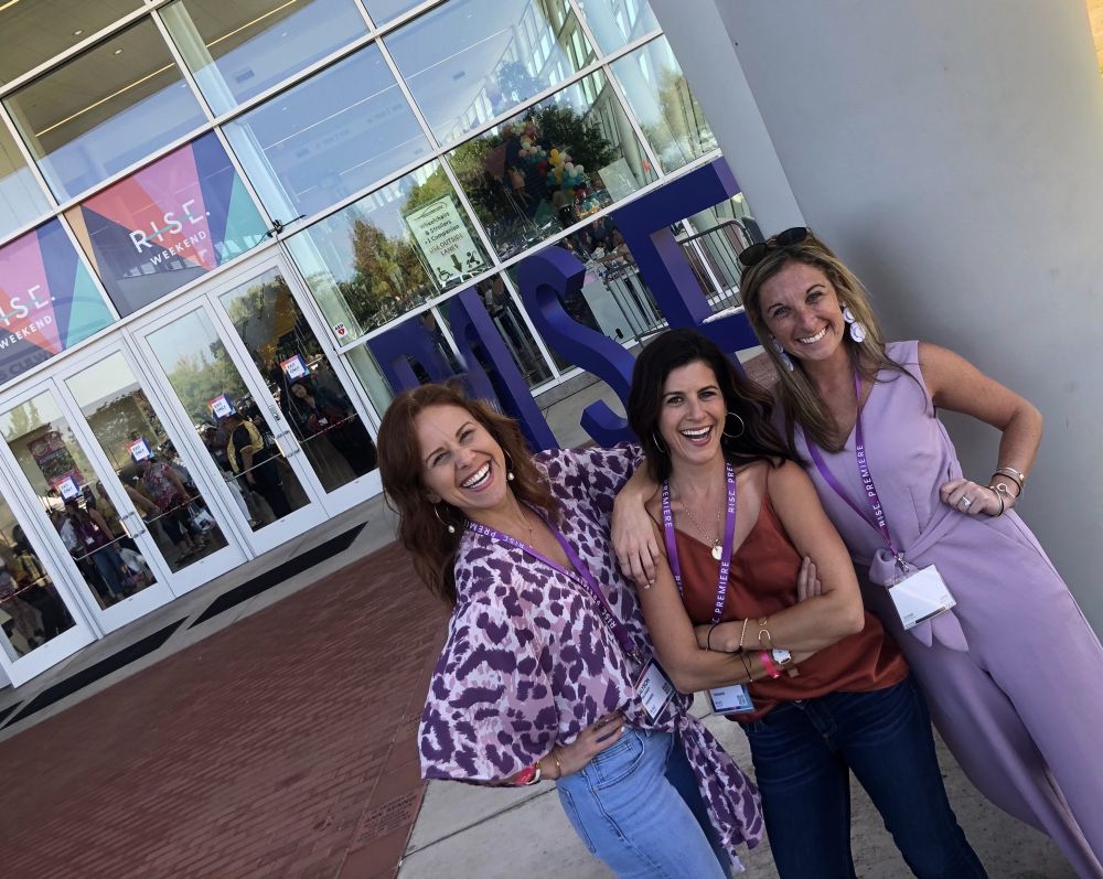 Alyson's Recent Favorites // July 2019 by popular Florida lifestyle blog: The Modern Savvy: image of a woman and two friends standing outside of a Rise conference.