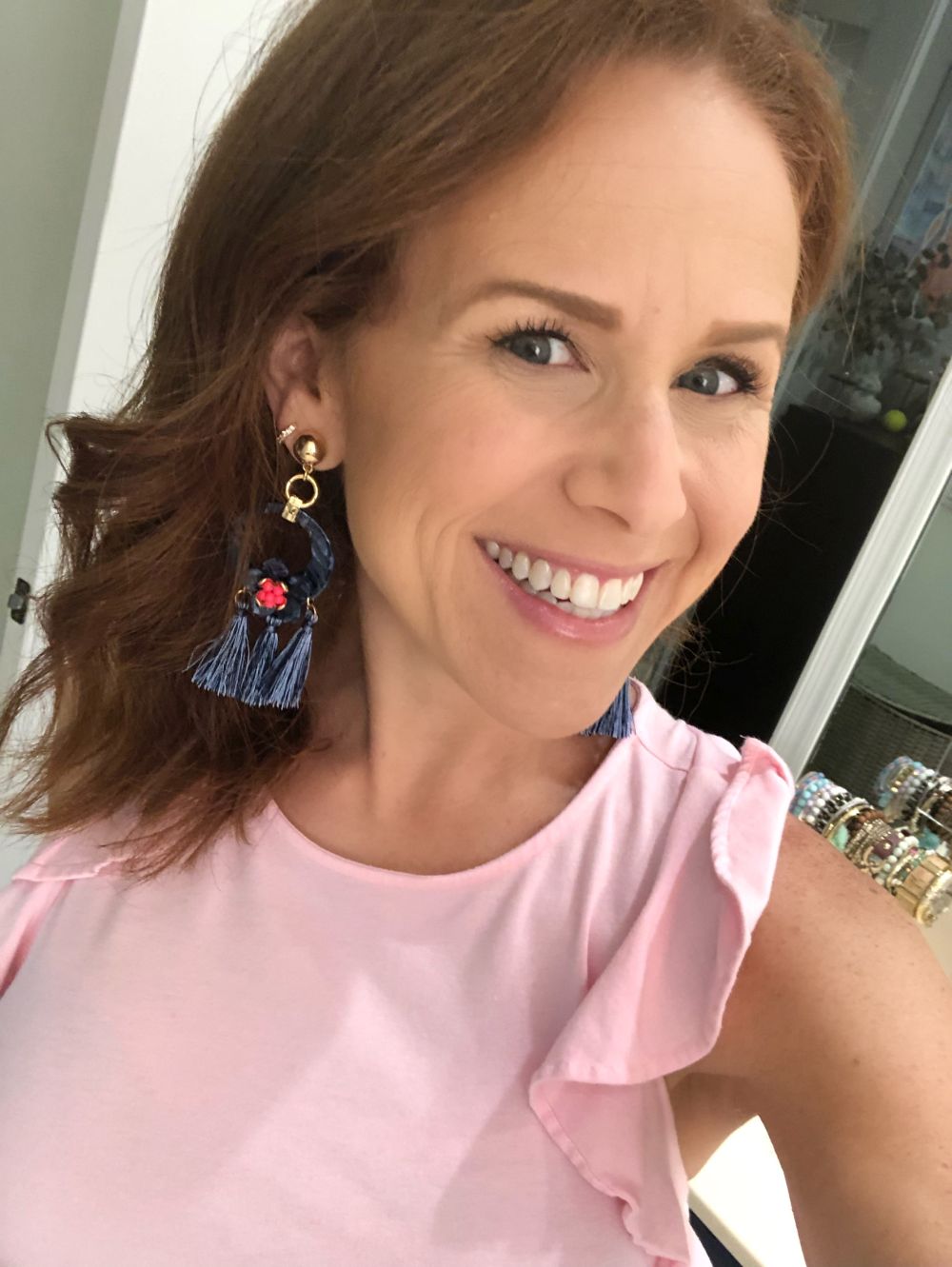 What to Get at the Lilly Pulitzer After Party Sale by popular Florida fashion blog, The Modern Savvy: image of a woman wearing Lilly Pulitzer MARITIME EARRINGS and LANETTE TOP.